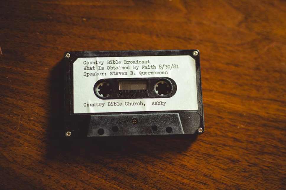 cassette tape with faded handwritten label "wasted a" on a wooden table