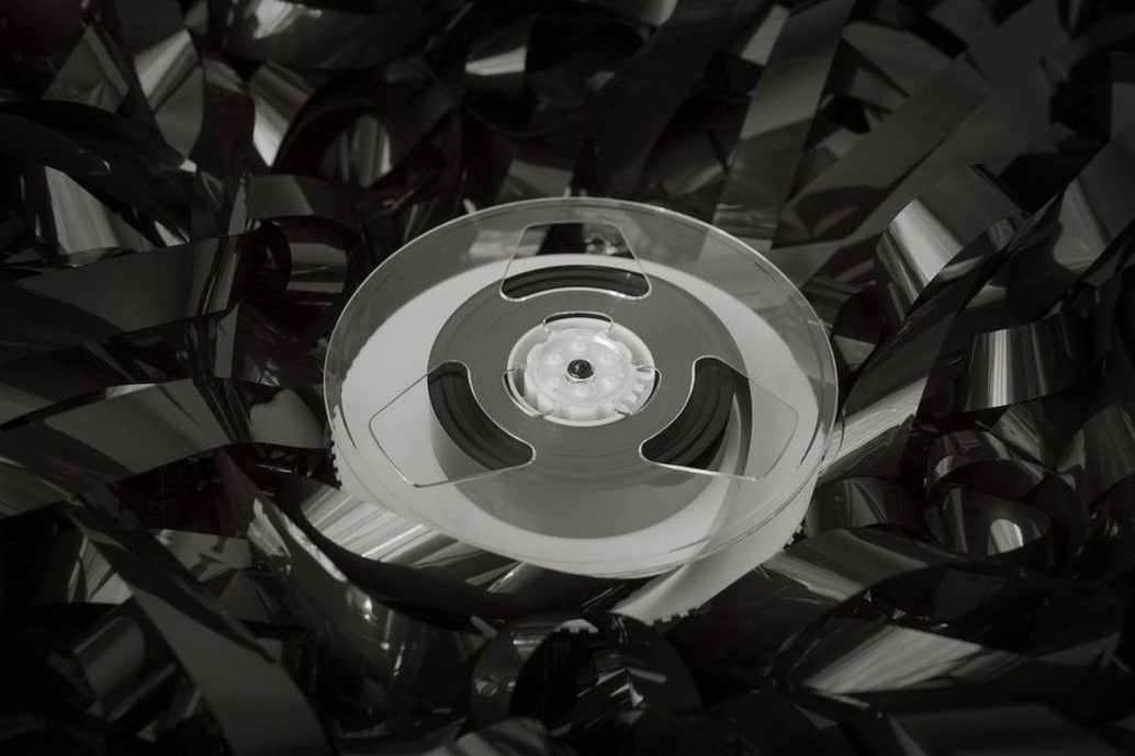 broken cassette tape with loose magnetic ribbon on a table
