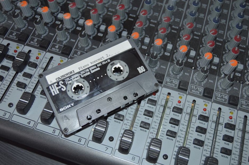 Hand-labeled cassette tape on a recording desk