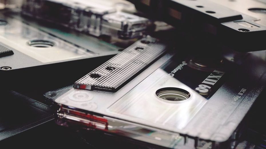 close-up of a cassette deck playing an orange-shelled tape