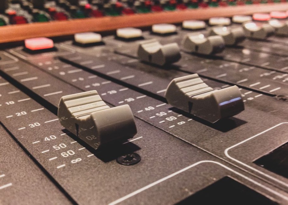 analog audio mixer with worn knobs and patch cables