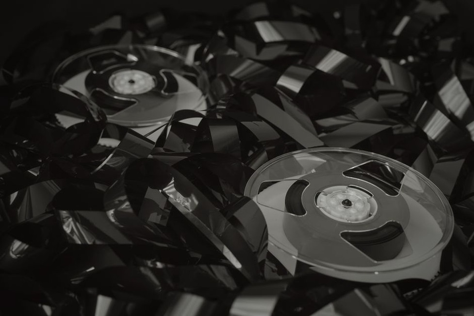 exposed magnetic tape on a cassette reel with dust particles