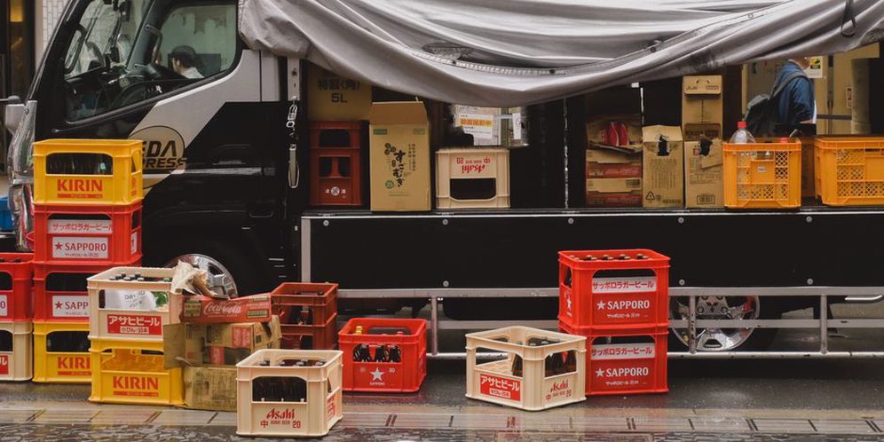 hand truck with cassette boxes on urban pavement
