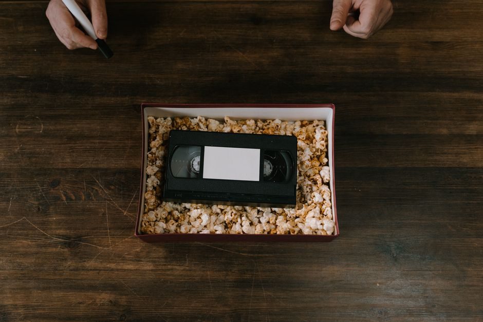 cassette with handwritten label resting on weathered wood surface