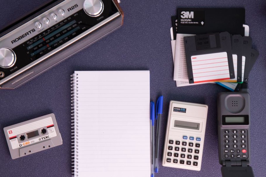 recording equipment and notes on a cluttered desk