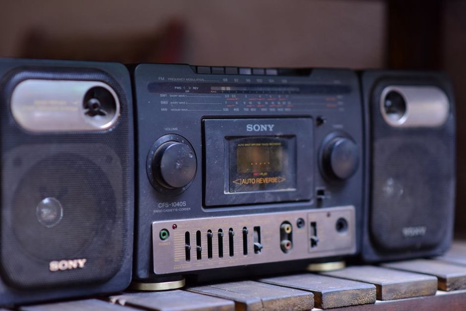 worn magnetic tape spilling from a cracked shell beside hand-built circuits