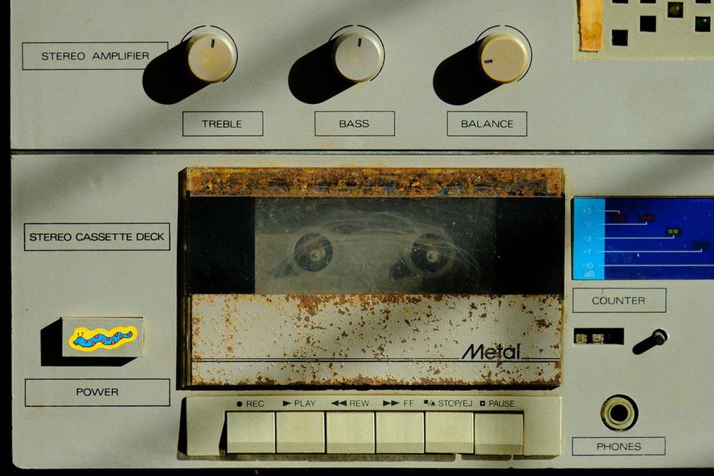 A worn cassette shell with handwritten text partially faded