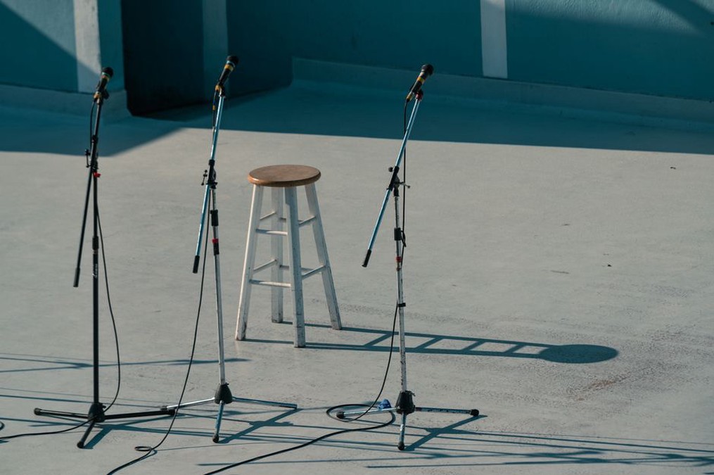 Three microphones positioned in an equilateral triangle for field recording
