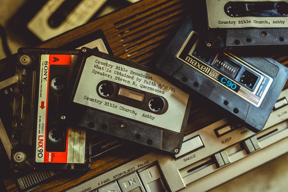 two cassettes numbered one and two on a wooden table