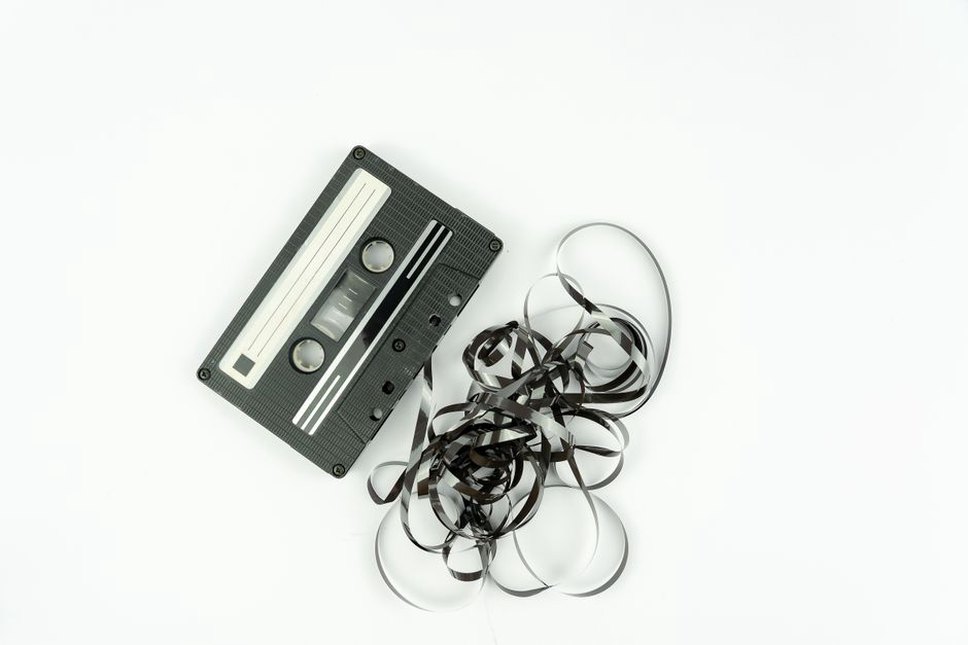 Worn cassette equipment and cables in a DIY workspace