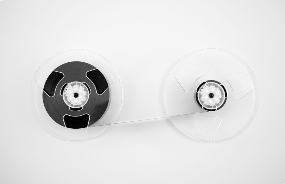 Tape, scissors, and a small recorder on a worktable