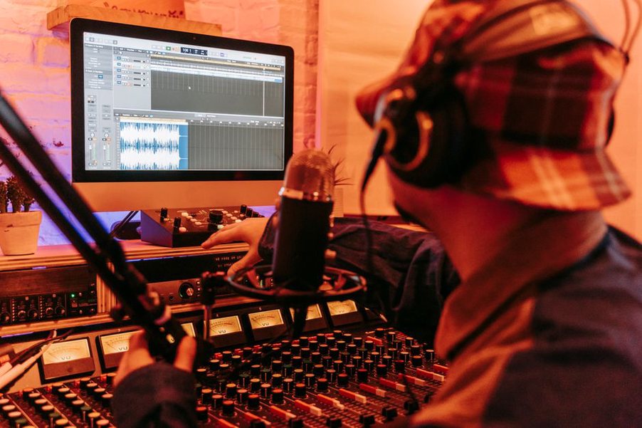 A tape recorder beside headphones and sound notes