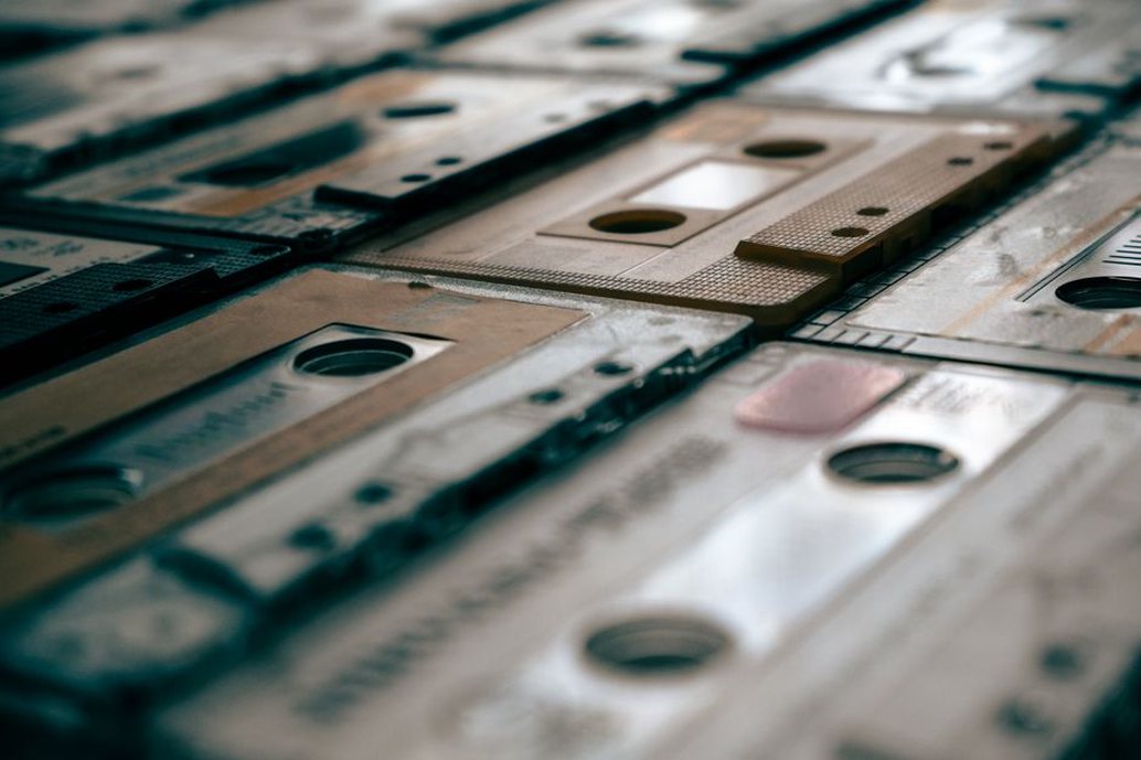 Hand-labeled tapes arranged beside a compact recording setup