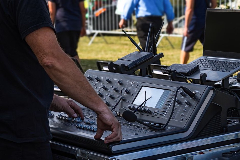 A small mixer beside instruments on a performance table