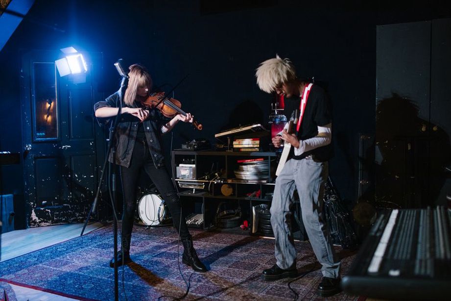 Musicians adjusting an acoustic and electronic setup