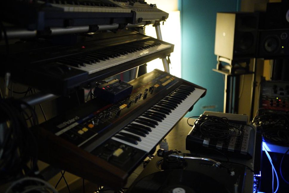 Knobs and patch cables in a compact electronic studio