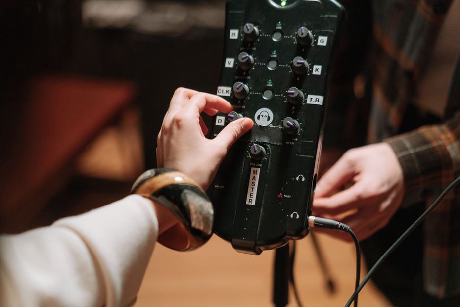 A performer works the controls of a small mixer