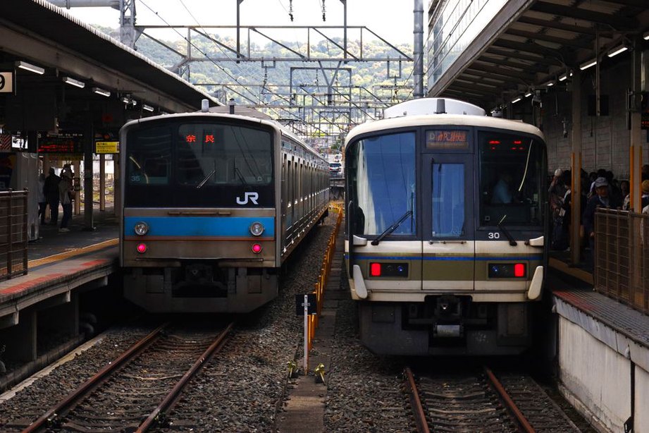 A handheld recorder near a busy platform