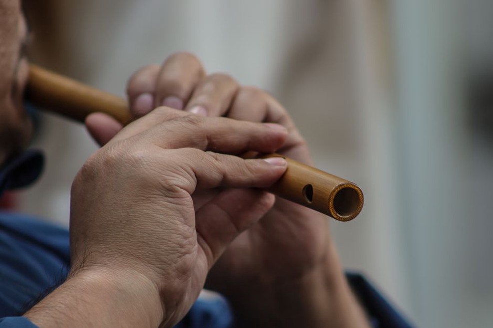 Fingers resting on a bamboo flute