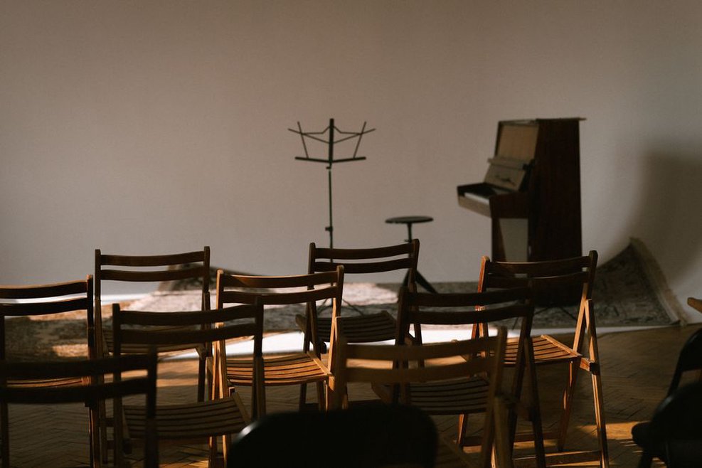 Speakers face a close row of chairs