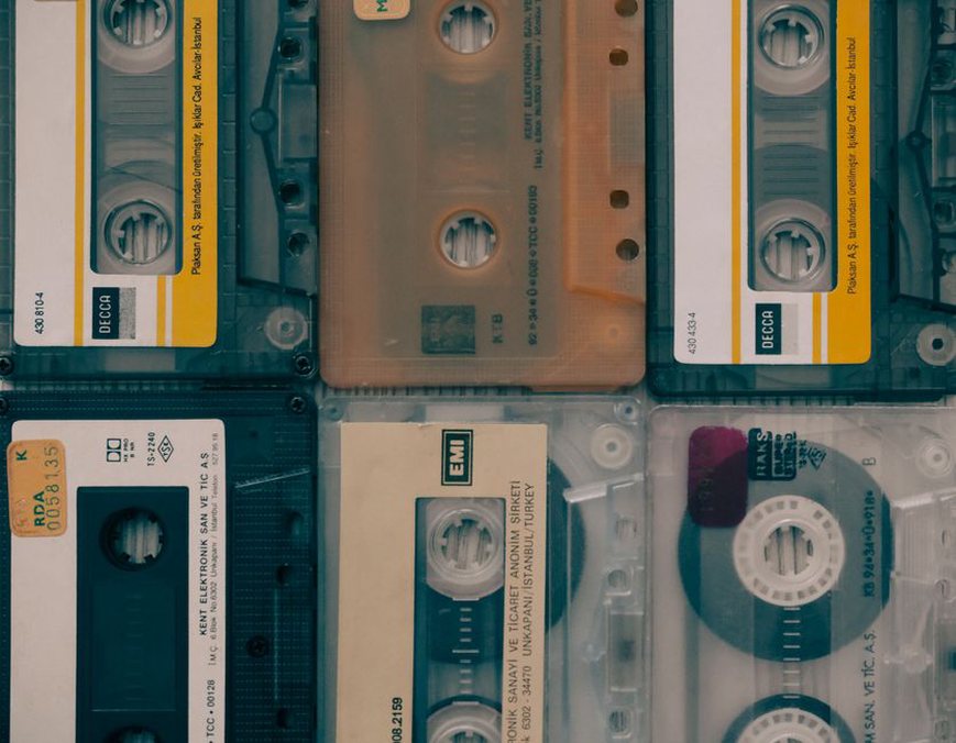 A stack of worn cassette tapes with hand-lettered Japanese track listings