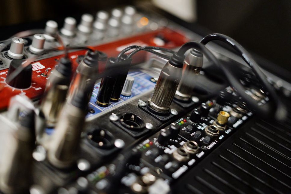 Cables cross a mixer beside the performance area