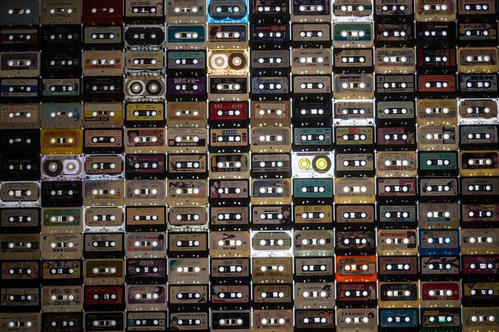 Cassette tapes beside a small mixing desk