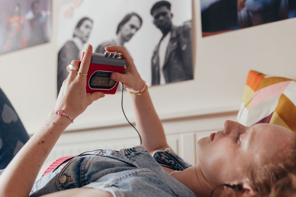 Cassette deck beside a pair of listening headphones