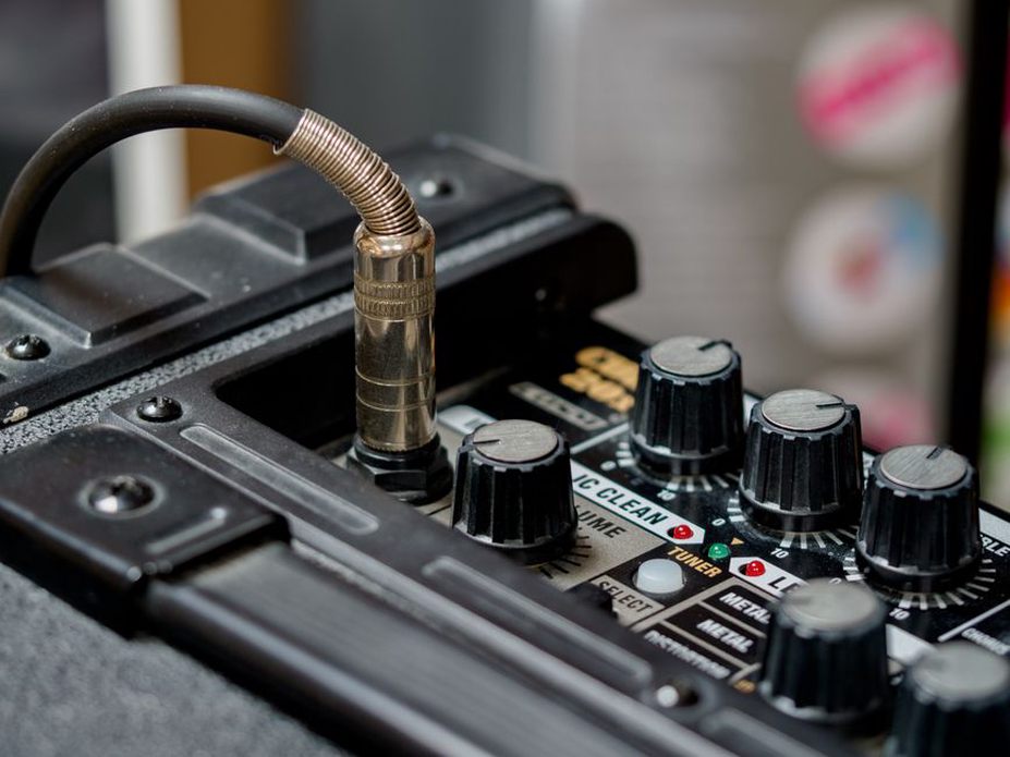 Patch cables connected across a small audio mixer