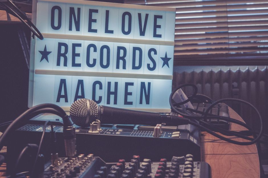 A crowded desk arranged for recording at home