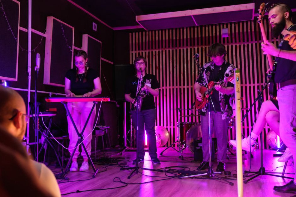 Listeners seated close to an experimental performance
