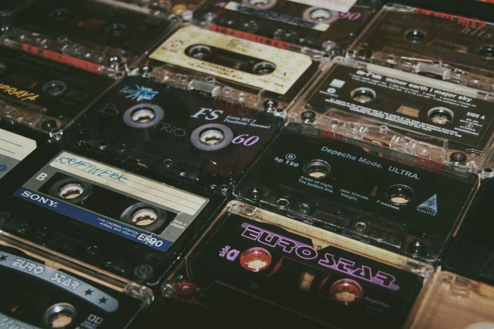 An editor checks a music article beside cassette tapes