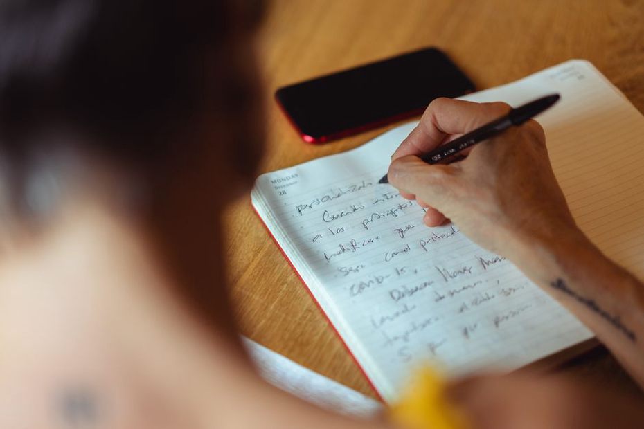 Handwritten listening notes sit beside a social post