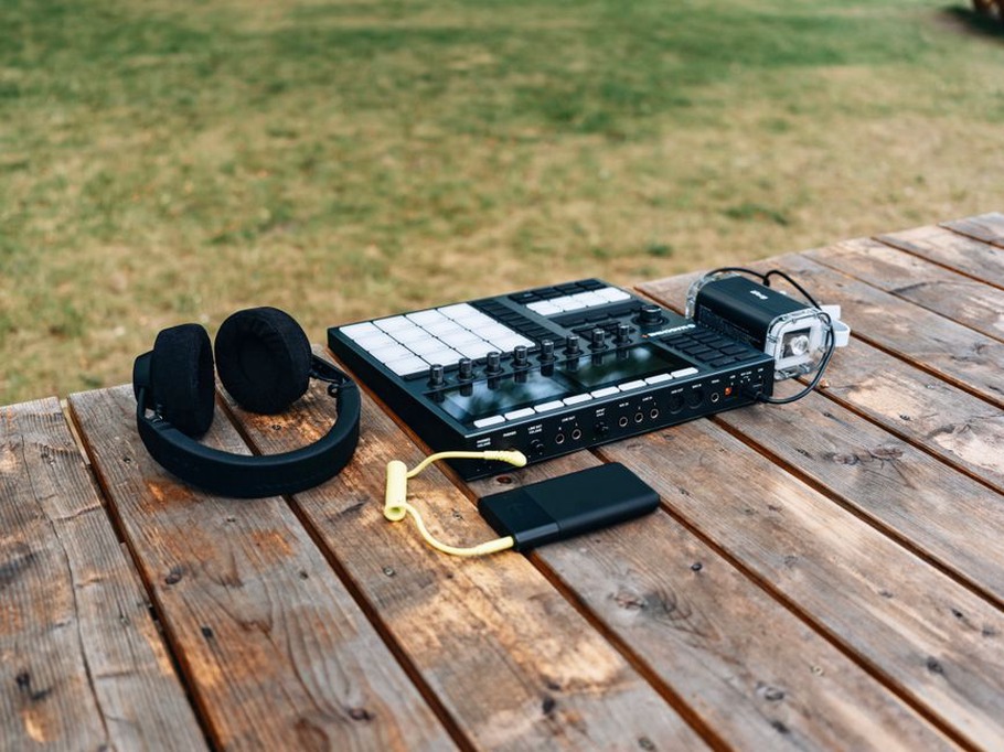 A recorder captures sound at the edge of a street