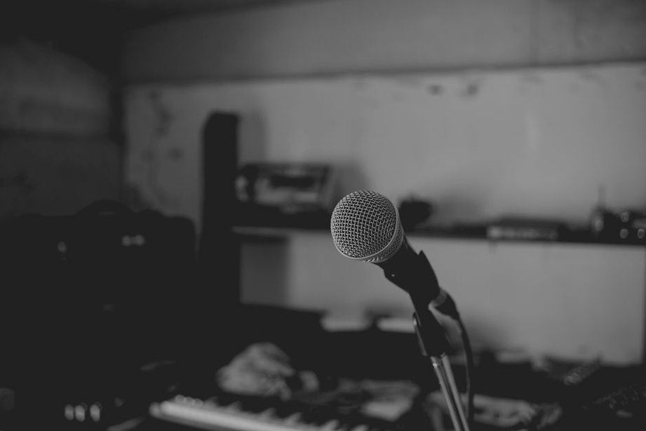 An empty chair beside a microphone stand