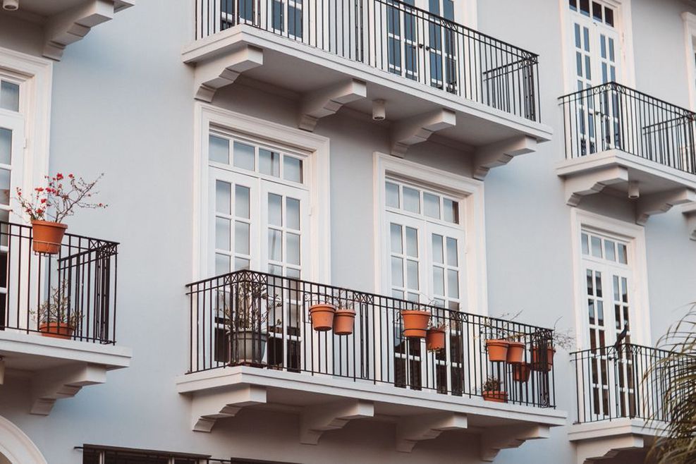 Pots arranged beside an open balcony walkway