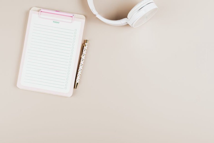 A printed checklist sits beside a working laptop